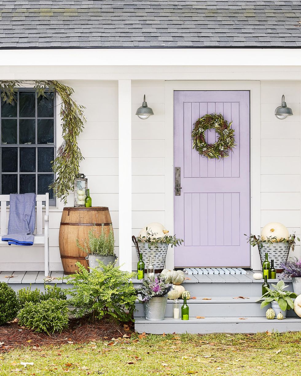 olive branch themed door decor with white pumpkins and a wine barrel
