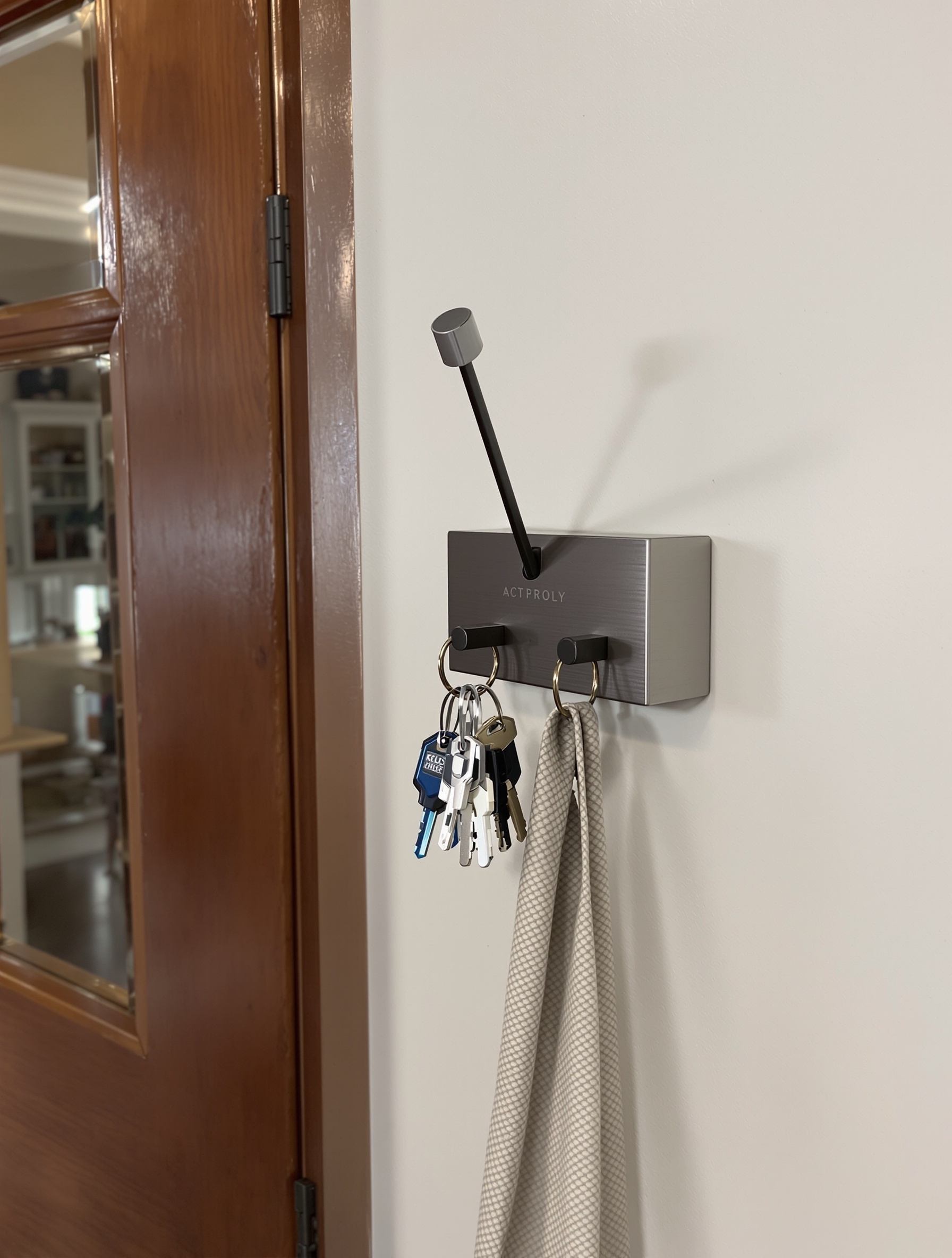 Modern wall-mounted key holder with keys and a towel